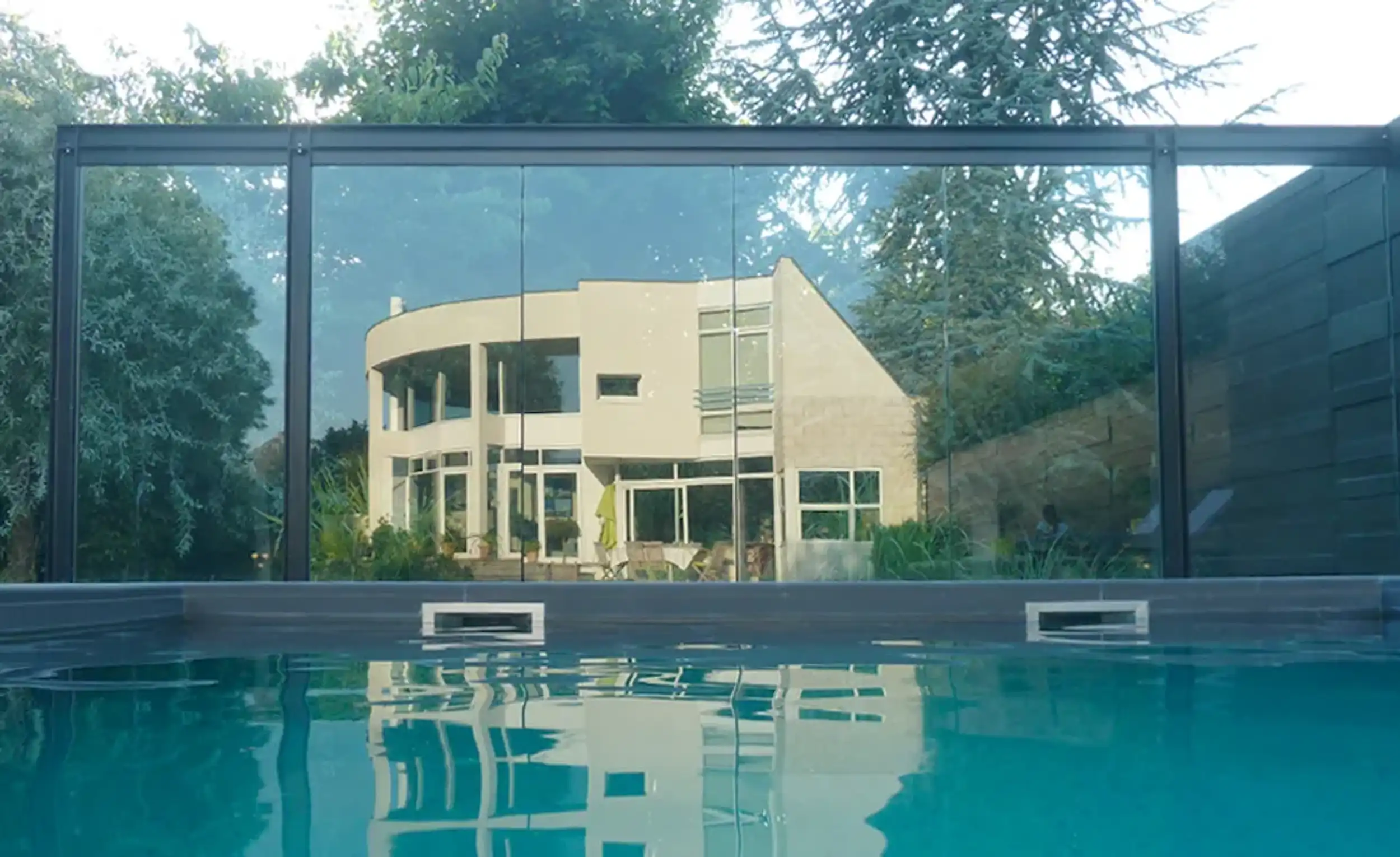 réflexion d'une maison dans les paroies de la piscine extérieure